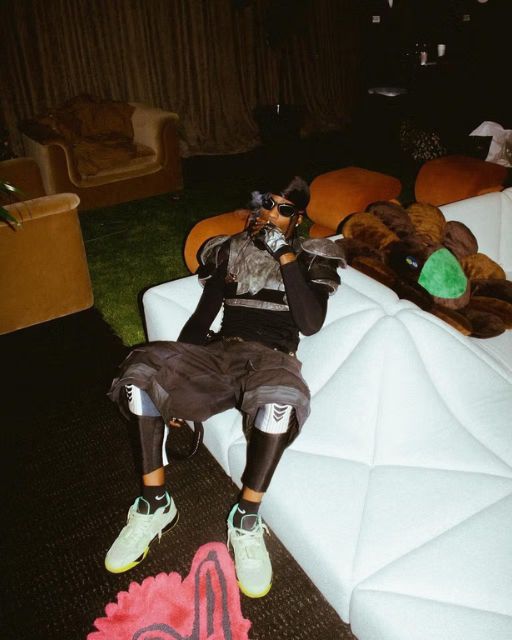 Travis Scott wearing the Jordan Jumpman Jack bright cactus shoes